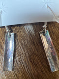 Silver earrings by Felicia Etcitty